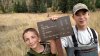 Cole and Brigham with trail sign, miles 8 miles in.jpg